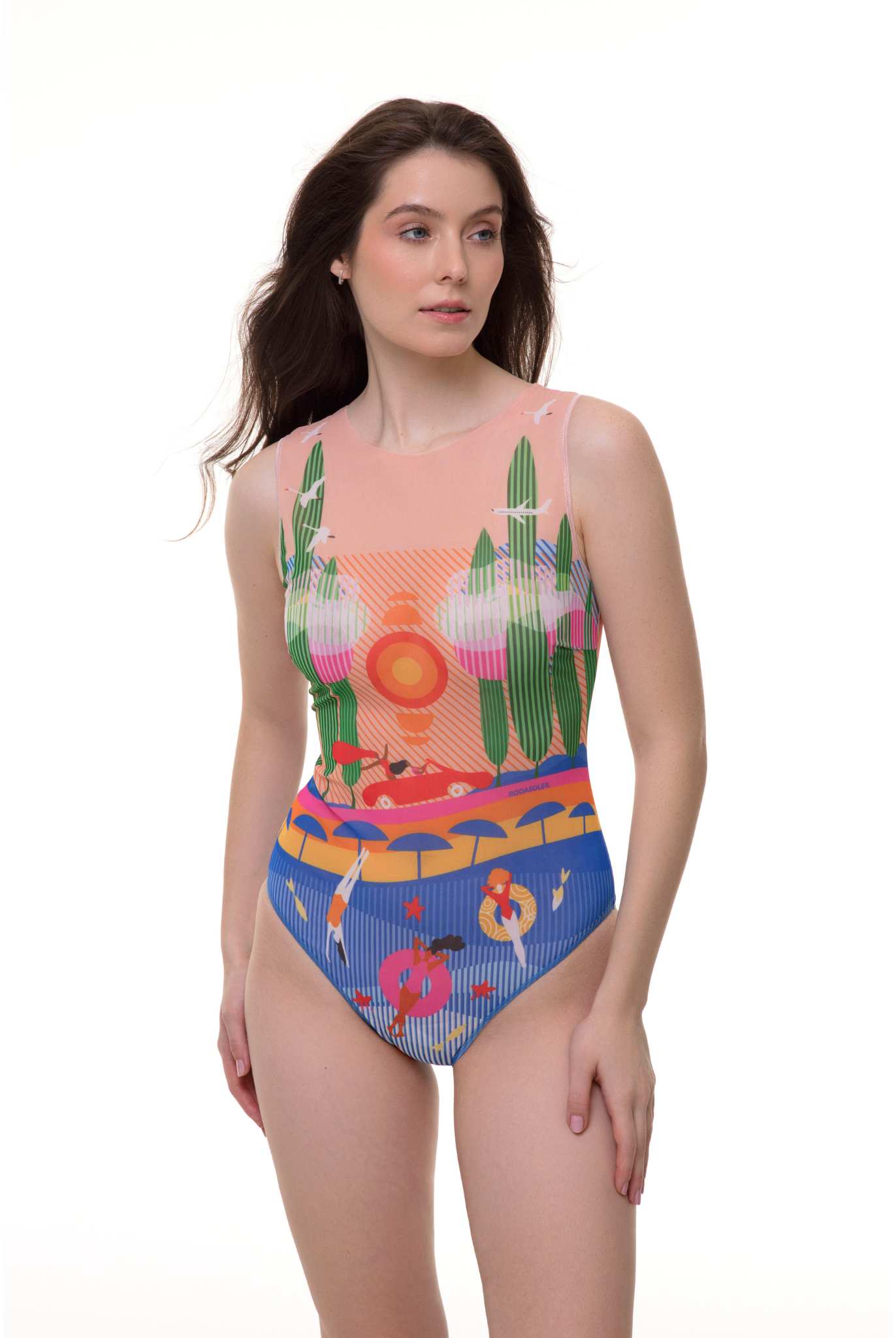 Full-body shot of a model in a Portofino Collection sleeveless one-piece swimsuit, featuring a stylish coastal print with blue and coral hues, standing on a white background.