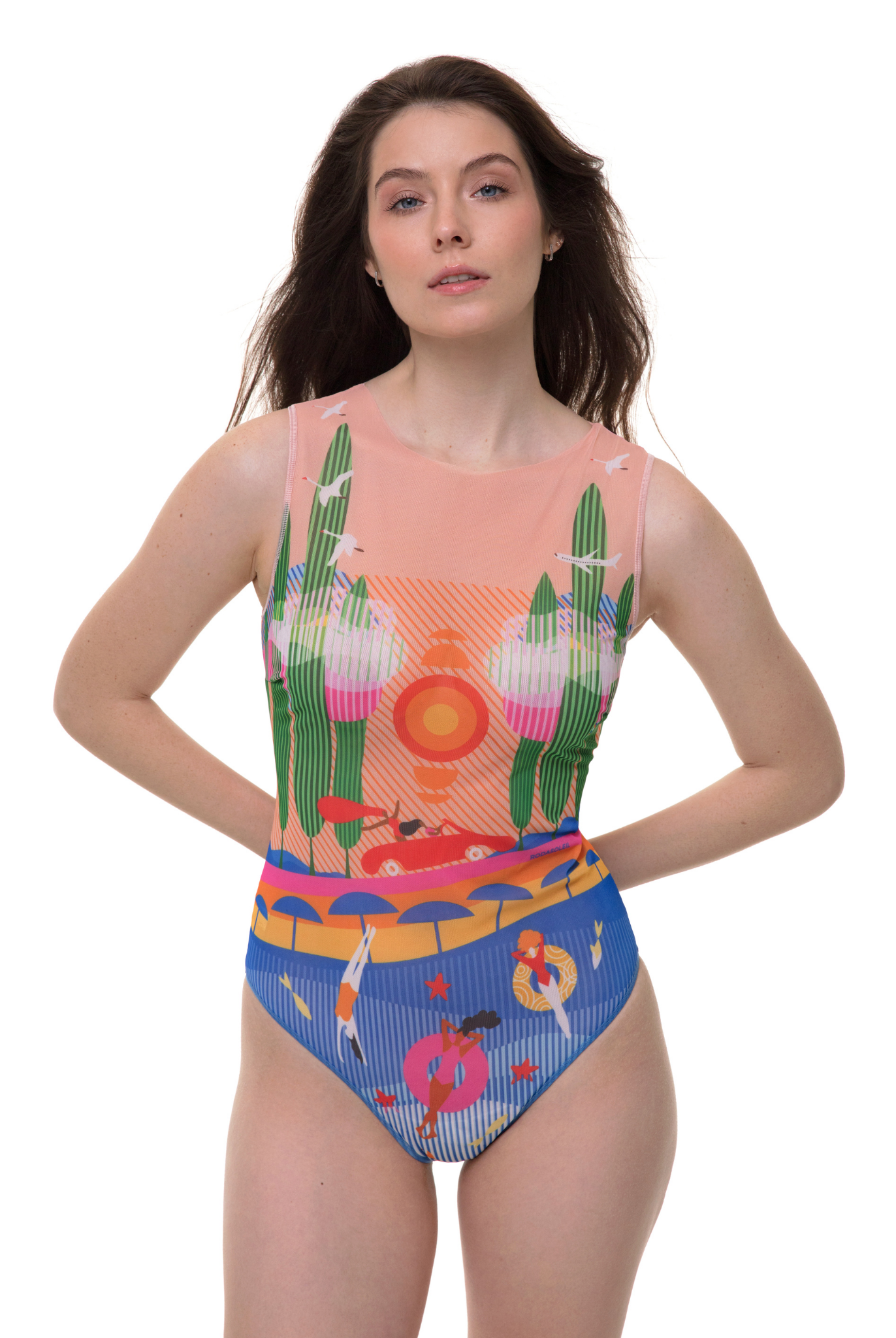 Model wearing a sleeveless one-piece swimsuit from the Portofino Collection, featuring a coastal print with blue and peach tones, standing against a white background.