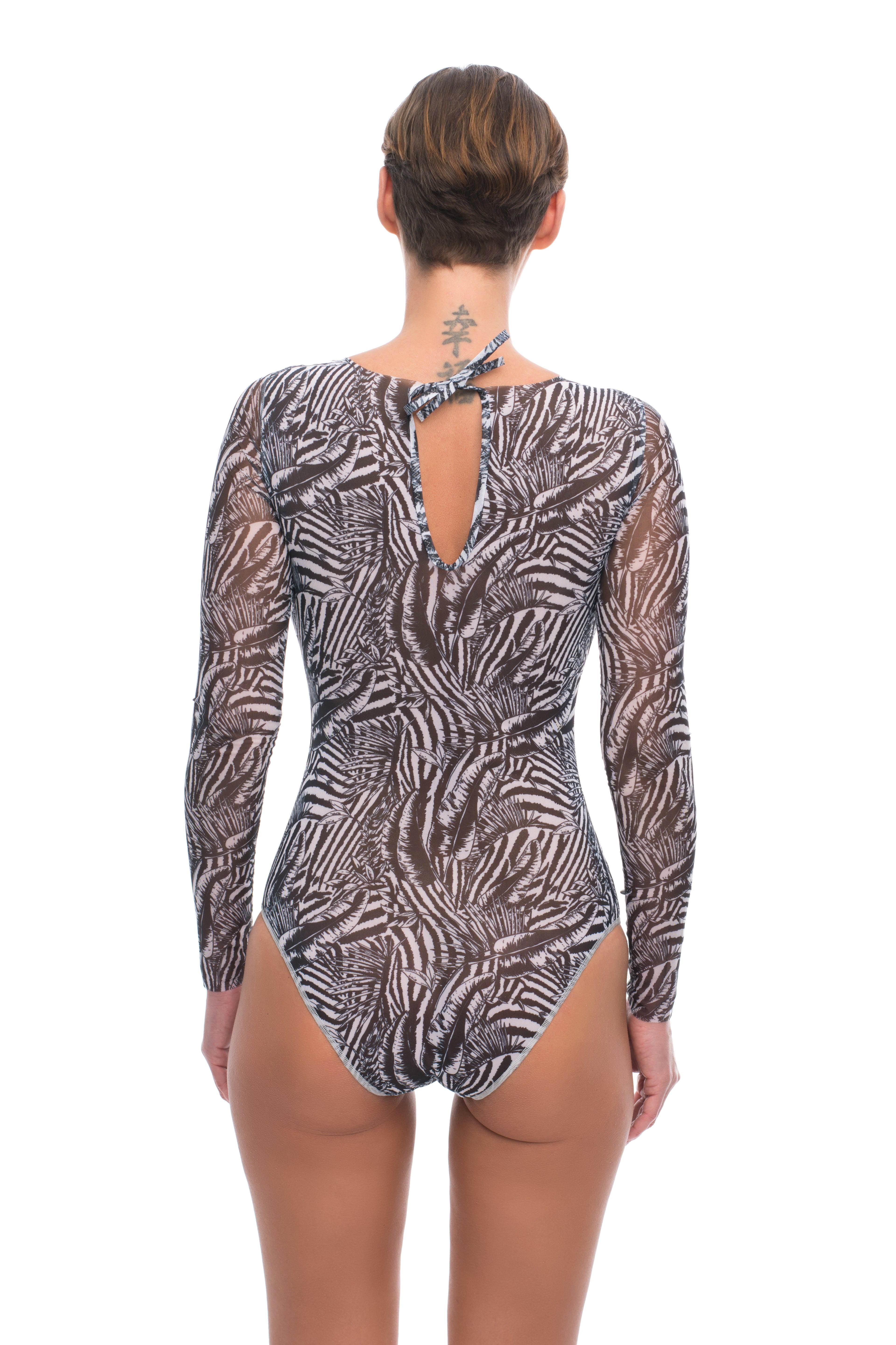 This file features sustainable tan-through smart swimsuits adorned with a Fake Zebra print. With a one-piece swimsuit design including sleeves, it offers an elegant and luxurious beachwear option perfect for the season