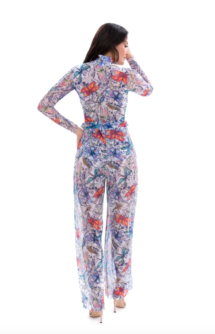 This file showcases tan-through sustainable smart swimwear adorned with a dragonflies print. Featuring beach pants, as seen at Hawaii Fashion Week, it offers stylish and eco-friendly beach attire options.