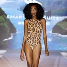 Explore sustainable tan-through smart swimsuits with a leopard print in this file. Featuring a one-piece swimsuit, as seen in Vogue, it offers fashionable and eco-friendly beachwear options